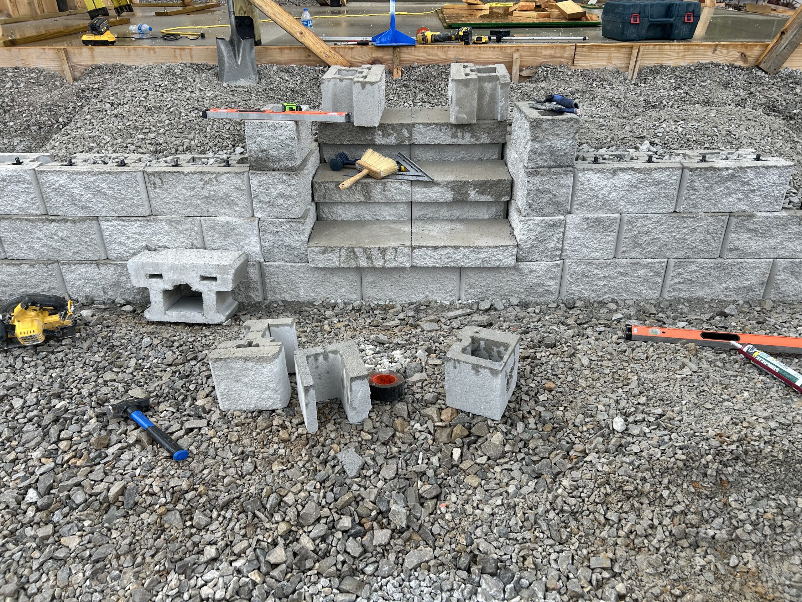A partially built concrete block retaining wall and steps