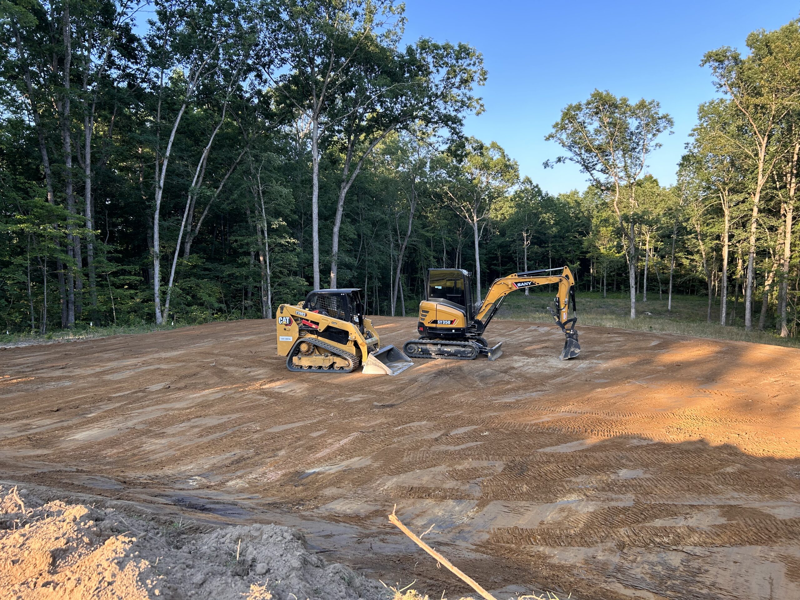 Excavator and a Caterpillar skid steer