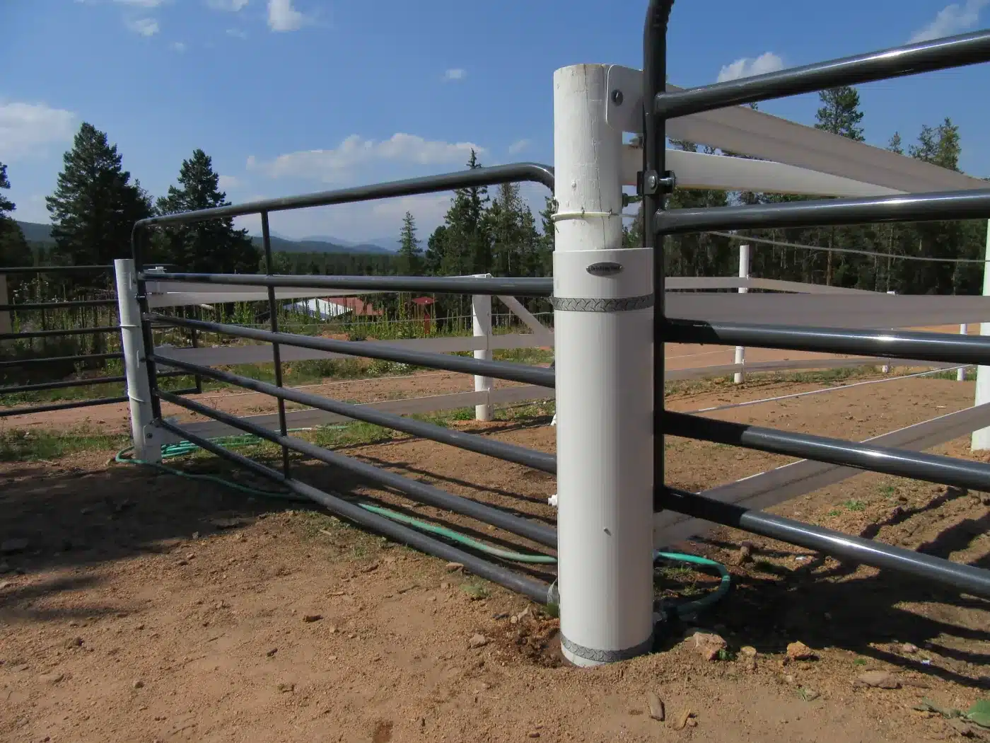 Installed Drinking Post waterer mounted by a fence